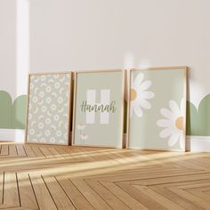 three framed pictures sitting on top of a wooden floor