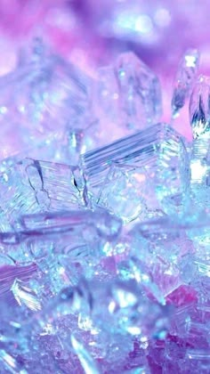 close up view of ice cubes on top of each other in blue and pink