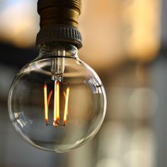 an old fashioned light bulb hanging from a ceiling