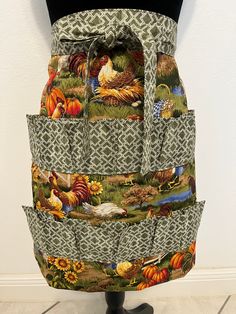 an apron made out of fabric with turkeys and sunflowers on the front