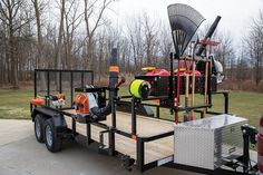 a utility trailer with equipment on the back and side rails, attached to a red fire hydrant