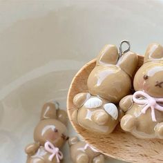 some little brown teddy bears in a wooden spoon