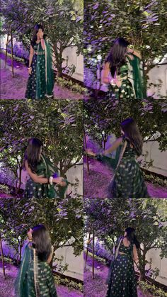 the woman is wearing a green and black sari while standing in front of some trees