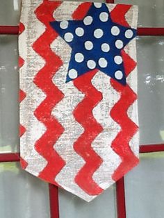 a red, white and blue tie is hanging on the front door with polka dots