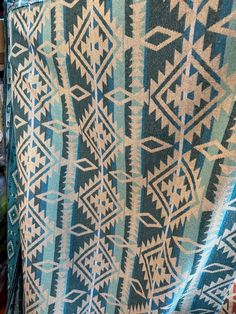 a blue and white blanket sitting on top of a shelf