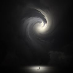 a man standing in the middle of a dark ocean under a large, swirling cloud