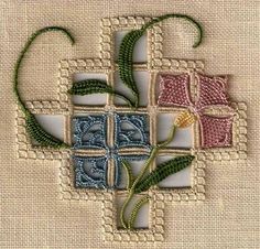 a cross made out of squares with flowers on it's sides and green stems in the middle