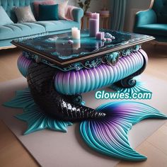 a coffee table with a fish design on it and candles sitting on top of it