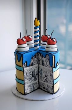 the cake is decorated with comic pages and cherries