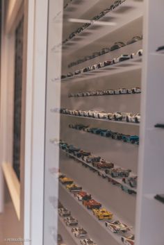 a display case filled with lots of toy cars