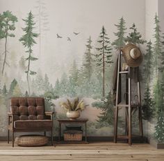 a living room with a chair, table and wallpaper that has trees on it