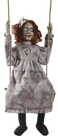 a doll with red hair and blue eyes is sitting on a swing, wearing a gray dress