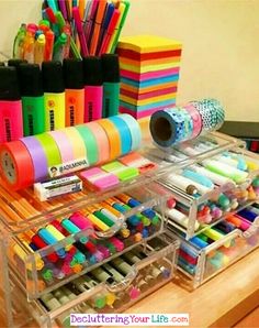 an organized desk with pens, markers and pencils