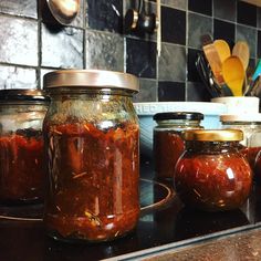 jars filled with food sitting on top of a stove