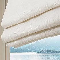 an open window with a view of the water and mountains outside it, in front of a white curtain