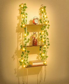 three shelves with plants and lights on them