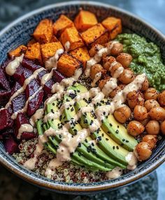 a bowl filled with different types of vegetables and sauces on top of each other