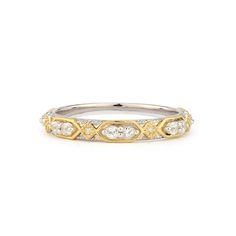 a white and yellow gold ring with diamonds