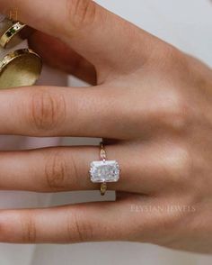 a woman's hand with an engagement ring on it