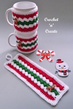 a crocheted coffee cup and mug cover with christmas decorations on the side, along with a snowman ornament