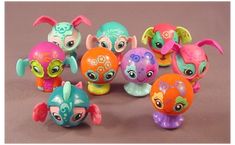 the littlest pet shop toys are all different colors and sizes, including one with large eyes