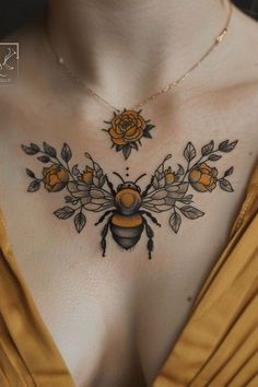 a woman's chest is adorned with flowers and a bee on the chest area