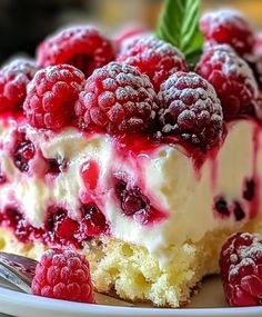 a piece of cake with raspberries on top