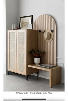 a wooden cabinet sitting next to a white wall with a hat on top of it