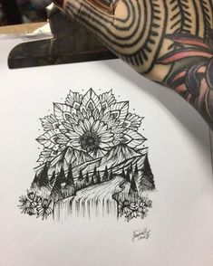 a drawing of a sunflower with mountains and trees in the background is shown on a piece of paper