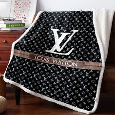 a louis vuitton blanket on a chair