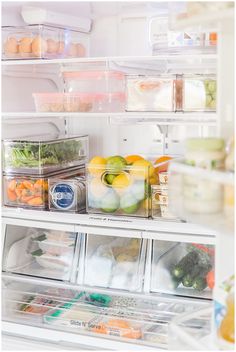 an open refrigerator filled with lots of different types of vegetables and fruit in containers on the shelves