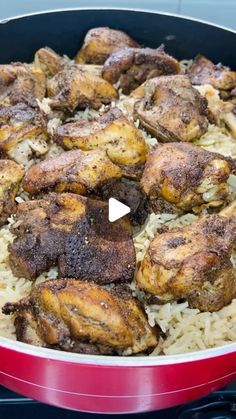 chicken and rice cooking in a pan on the stove