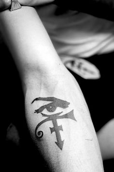 a person with a tattoo on their arm and an eye drawn on the side of his arm