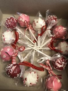 a box filled with pink and white cake pops