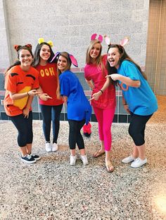 four girls in costumes posing for the camera with bunny ears on their heads and arms