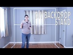 a woman standing in front of a window with the words diy back drop stand