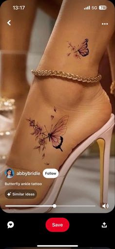 a woman's foot with butterfly tattoos on it and a chain around the ankle