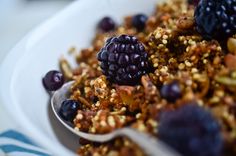 a white bowl filled with granola and berries