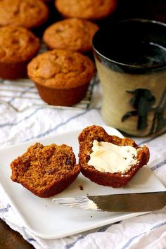 muffins on a plate with butter and a cupcake in the foreground