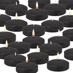 many black candles are lit in rows