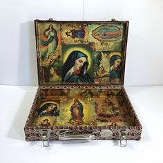 an open suitcase with paintings on it