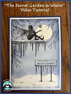 the secret garden in winter's video guide is displayed on a wooden plaque with an image of a fairy sitting on a bench