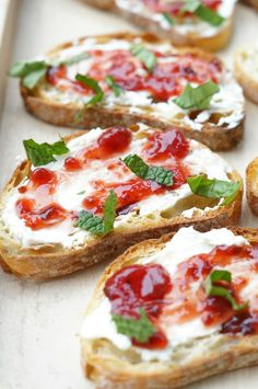 several pieces of bread topped with cheese and toppings