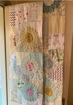 a close up of a door with many different types of quilts hanging on it