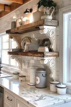 a kitchen with white cabinets and shelves filled with pots, pans and utensils