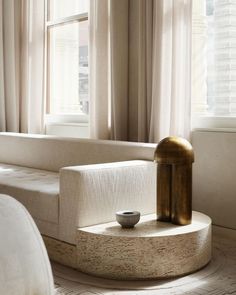 a white couch sitting next to a window in a living room