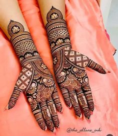 two hands with henna tattoos on them