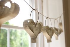 some paper hearts hanging from a string