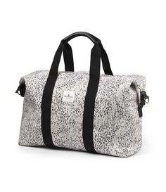 a leopard print duffel bag with black straps and white spots on the front, it is