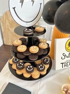 an assortment of desserts on a table with balloons in the background and a sign that says sweet treats